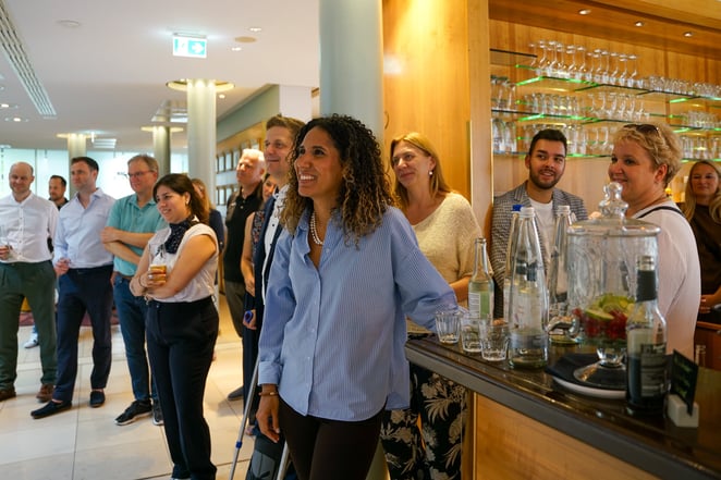 Gäste des MICE Executive Circle 2026 (MEC 2026) bei der Begrüßung im Foyer von Chateauform am Starnberger See. Teilnehmende aus der MICE-Branche stehen lachend zusammen und freuen sich auf den gemeinsamen Auftaktabend des Branchentreffens von MICE Portal. Entspannte, herzliche Atmosphäre zum Get Together am Vorabend des Programms.